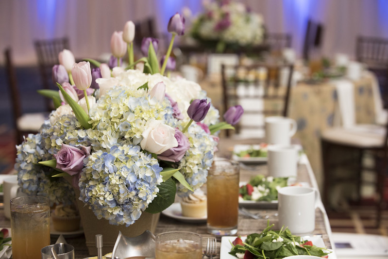 A lovely set table with food and a bouquet of flowers