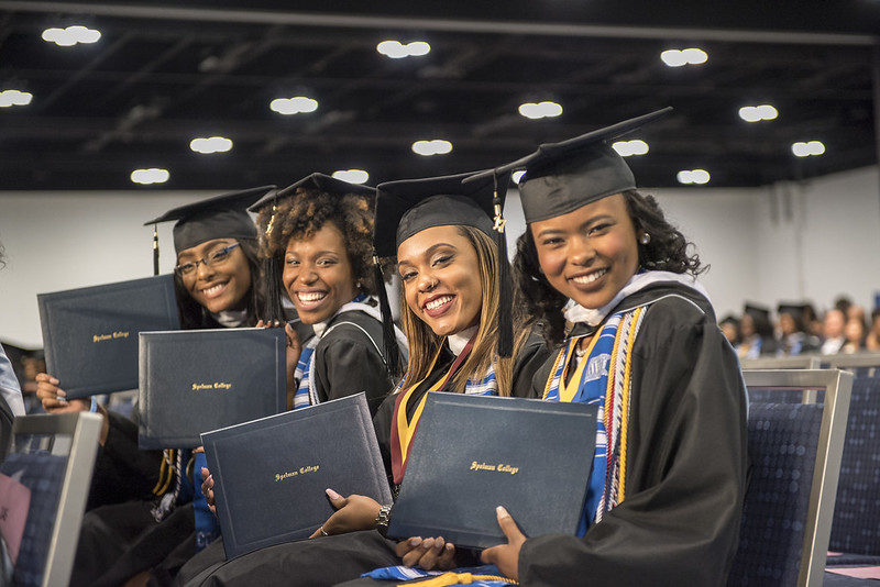 Group of Spelman Sisters holding diplomas.