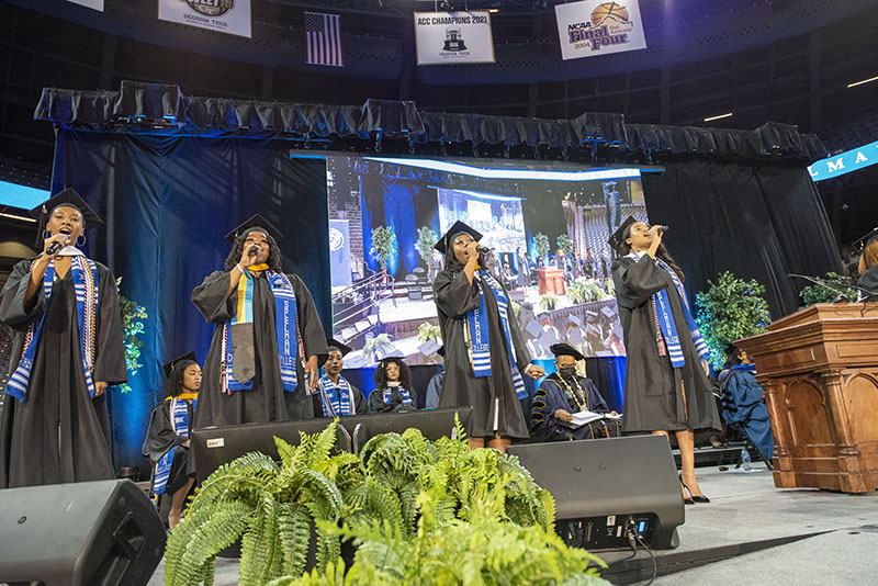 Spelman College Commencement 2022 - Spelman graduates singing on stage.