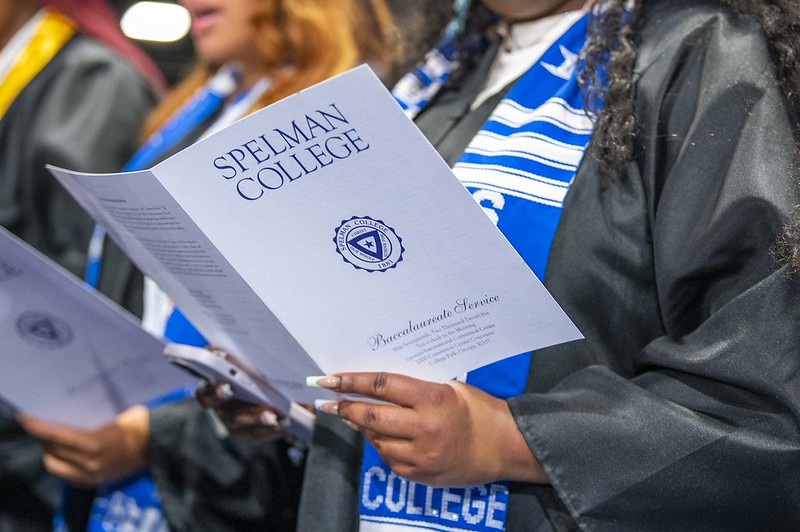 student holding program