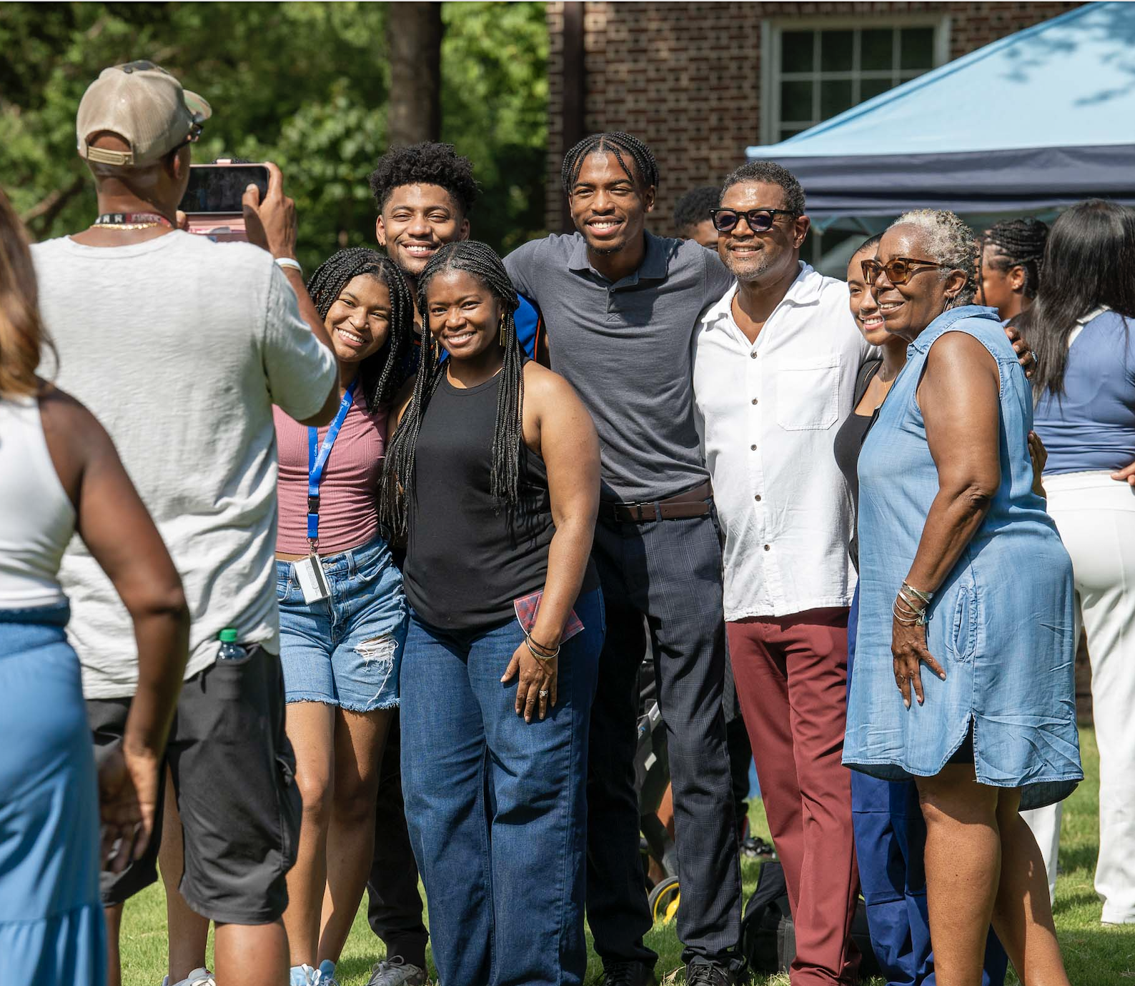 Excited students and families take photos during new student orientation