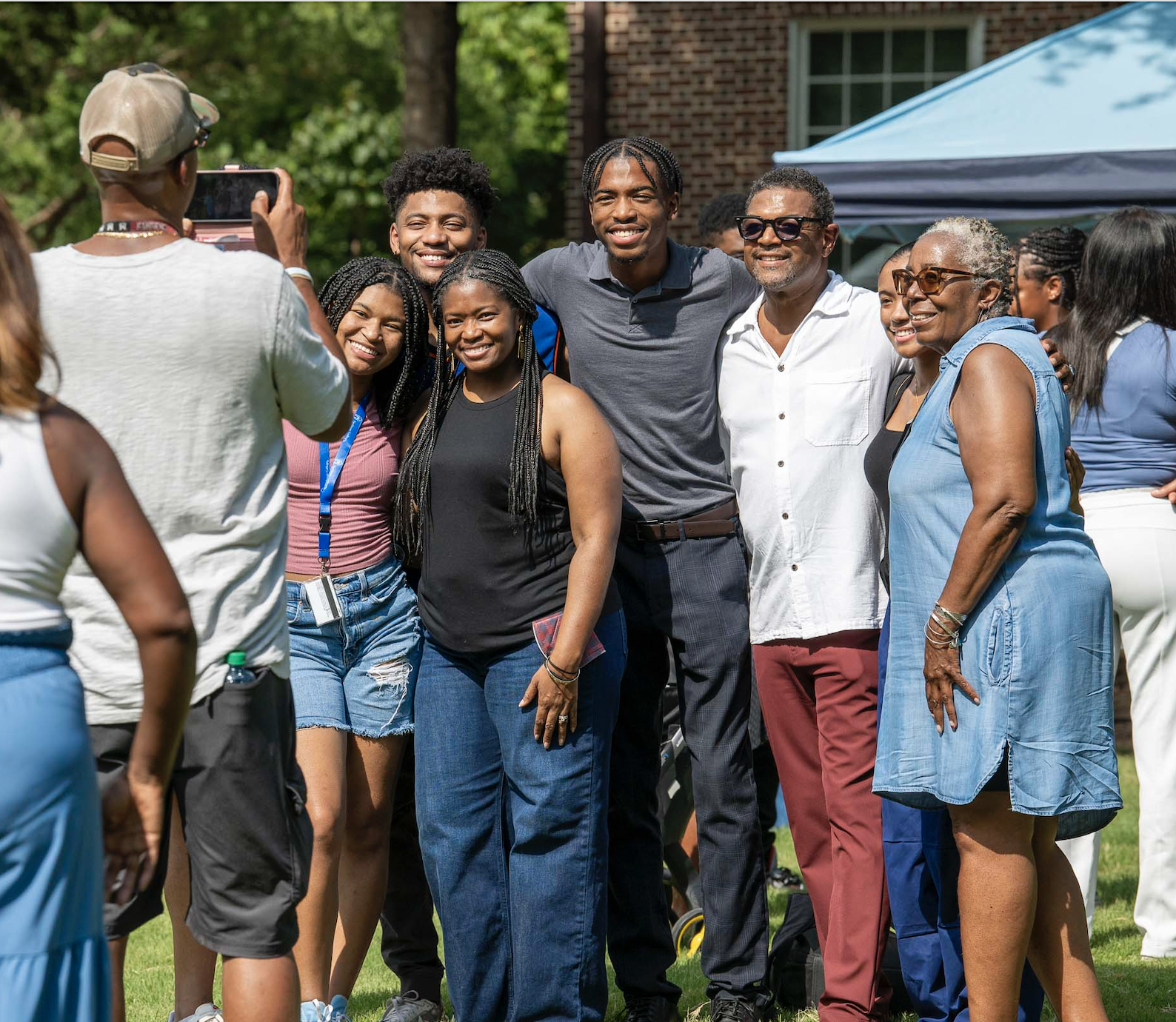 Excited students and families take photos during new student orientation 