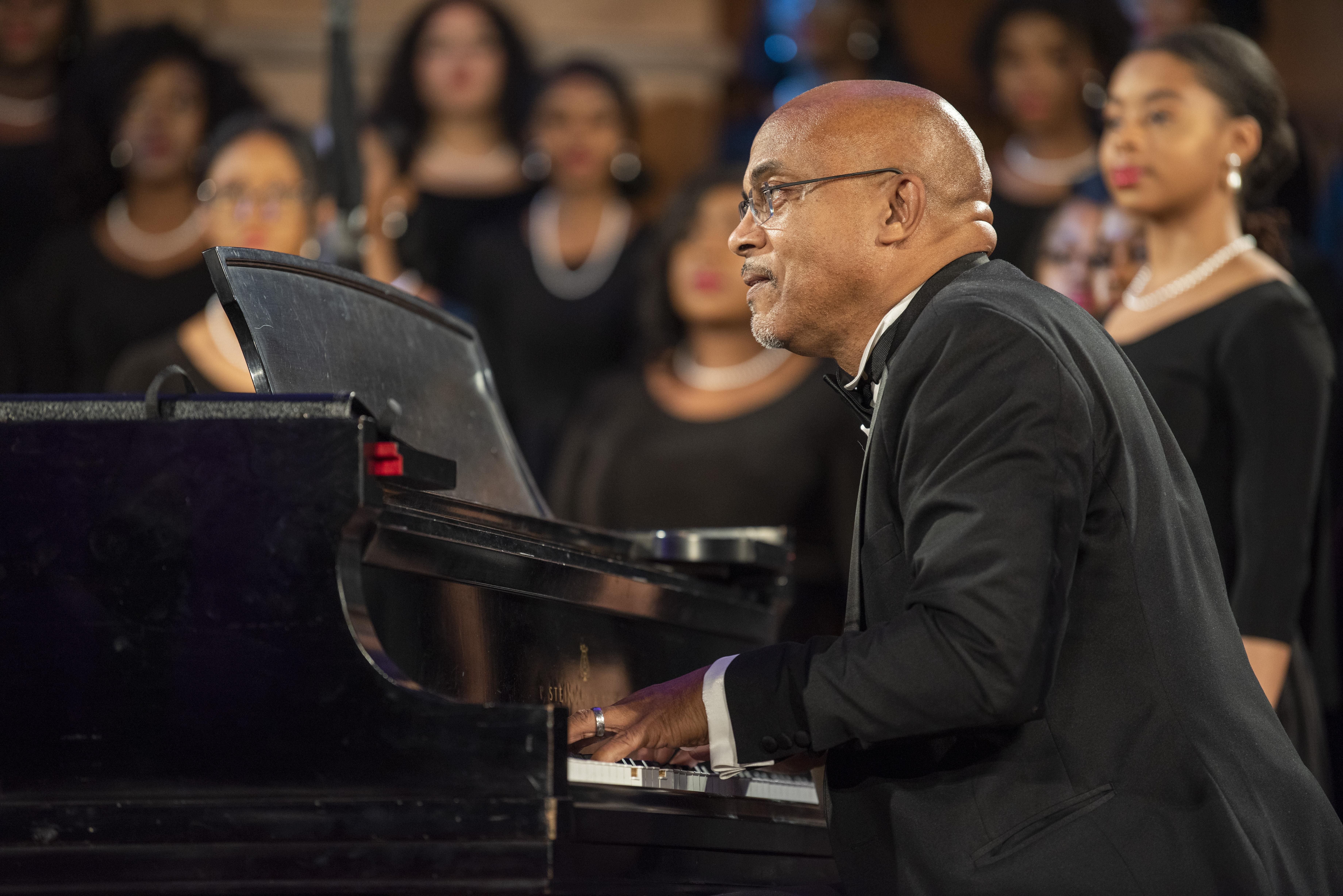 Dr Kevin Johnson playing piano at Glee Club performance