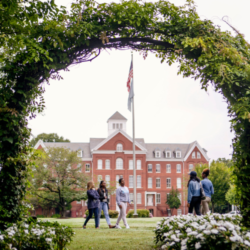 Students Walking Under Arch