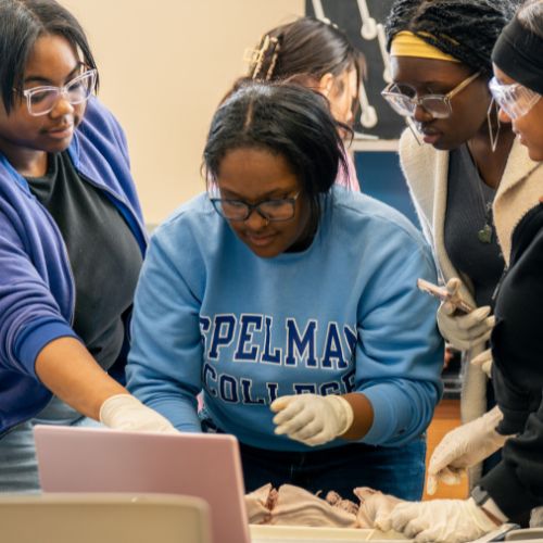 Stock photo of students over a computer